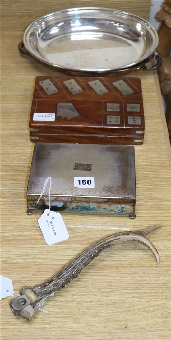 A plated cigarette box, an antler-handled cigar cutter, a plated entree dish and a wooden dominoes/card box with metal-inset top